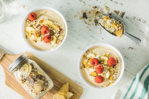 PASSIONFRUIT BANANA OATMILK YOGURT BOWL WITH MUESLI AND BERRIES